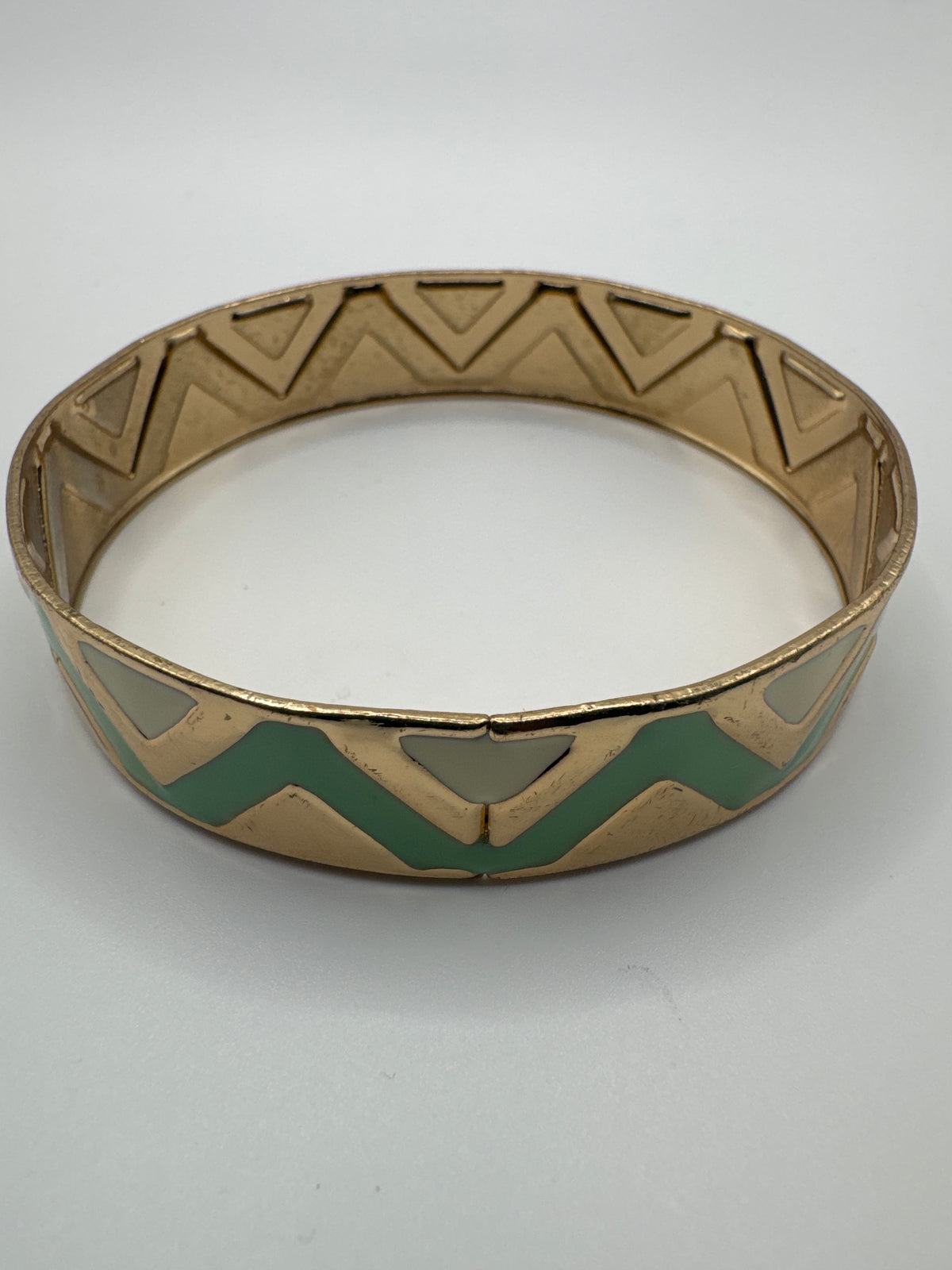 Gold-tone bracelet featuring a distinctive mint green and geometric inlay pattern