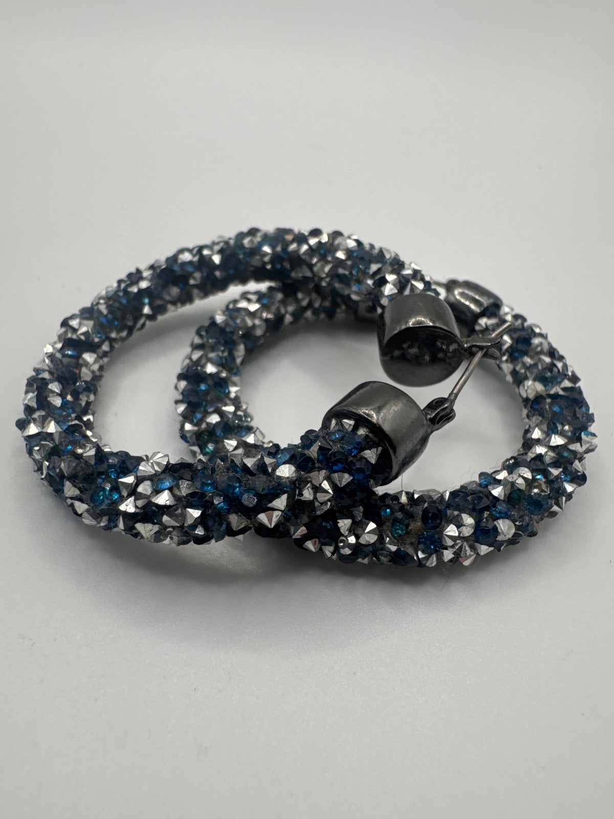 Silver-Toned Hoop Earrings Embedded with Sparkling Dark Blue and Iridescent Crystals