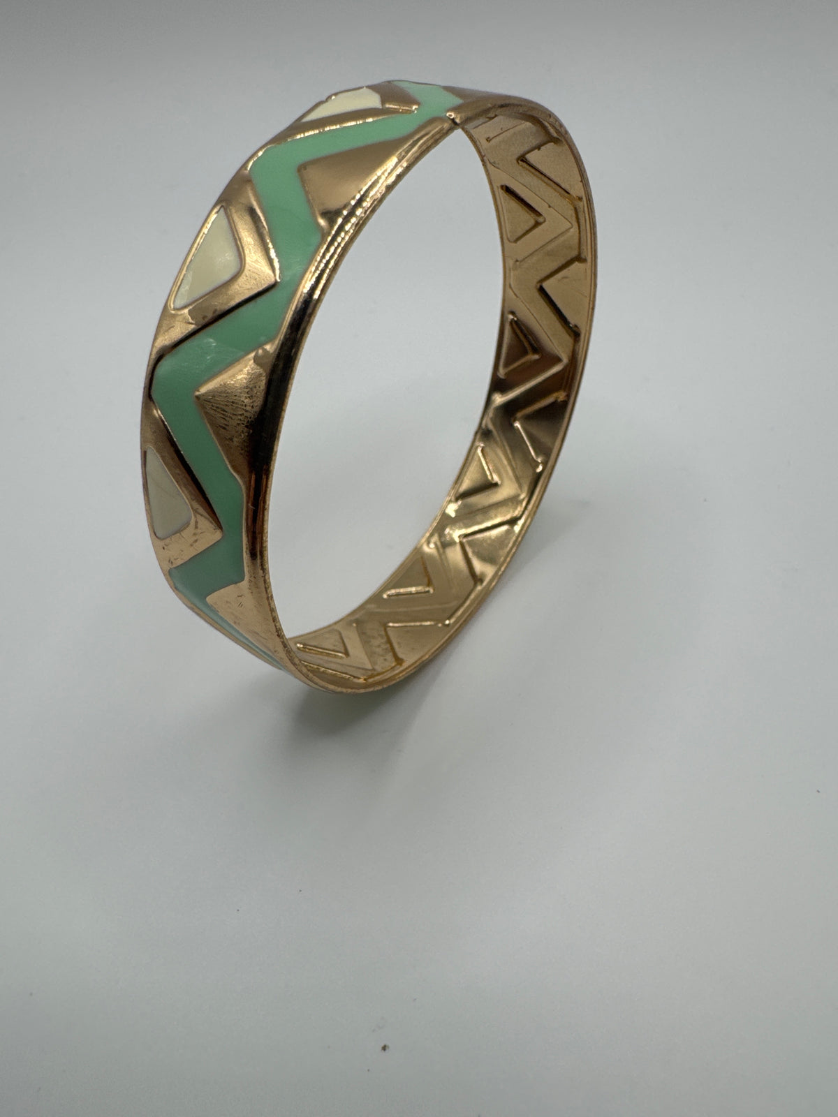 Gold-tone bracelet featuring a distinctive mint green and geometric inlay pattern