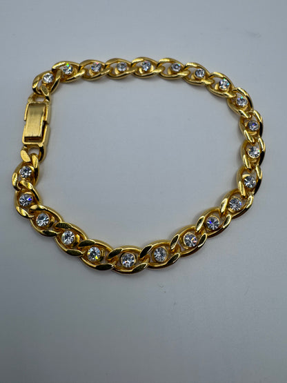 gold-tone curb link bracelet featuring sparkling clear rhinestones
